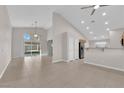 Open-concept living room features tile flooring, sliding glass doors, a barn door, and lots of natural light at 2514 Tropical Sands Ave, North Las Vegas, NV 89031
