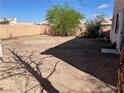 Large backyard with mature trees, desert landscaping and a tall privacy fence at 268 Dahlia St, Henderson, NV 89015