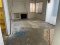 Spacious living room featuring a fireplace, large windows, and sliding glass doors for natural light at 268 Dahlia St, Henderson, NV 89015