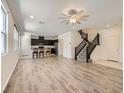 Open-concept living room with hardwood floors and staircase, perfect for entertaining at 2862 Starling Summit St, Henderson, NV 89044