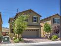 Attractive exterior shot of a two story home with a two car garage and desert landscaping under a clear blue sky at 2936 Aragon Terrace Way, Henderson, NV 89044