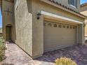 Close up of two car garage with brick paved driveway and desert landscaping at 2936 Aragon Terrace Way, Henderson, NV 89044