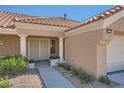 Inviting front entrance featuring decorative pillars, a security screen door, and tastefully landscaped surroundings at 3012 Haddon Dr, Las Vegas, NV 89134
