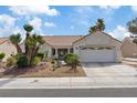 Charming single-story home with a well-maintained yard and a two-car garage at 3024 Lotus Hill Dr, Las Vegas, NV 89134
