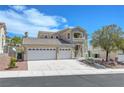 Two-story home with a three-car garage, drought resistant landscaping, and desert views at 3079 Evening Mist Ave, Henderson, NV 89052
