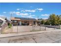 Single-story home featuring solar panels, a fenced yard, and a private driveway at 3112 Twining Ave, North Las Vegas, NV 89030