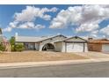 Charming single-story home featuring a two-car garage and low-maintenance desert landscaping at 325 Heather Dr, Henderson, NV 89002