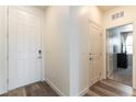 Bright entryway features wood flooring, a front door, and access to living spaces at 4517 Swimming Minnow Ave, Las Vegas, NV 89141