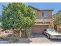Two-story home featuring a two-car garage and brick-paved driveway at 4902 Guysborough St, Las Vegas, NV 89148