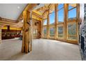 Spacious living room features floor to ceiling windows, log columns and views of the mountains at 4927 Snow White Rd, Las Vegas, NV 89124