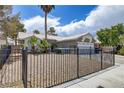 Inviting single-story home with a low-maintenance yard, wrought iron fence, and convenient two-car garage at 5045 Sock Hop Way, North Las Vegas, NV 89031