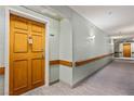 View of a well lit hallway with neutral walls, carpeted floors and handrails at 555 Highland Dr # 203, Mesquite, NV 89027