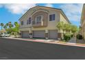 Beautiful condo building featuring attached garages, neutral colors, and modern design at 5553 High Wager Way # 101, Las Vegas, NV 89122