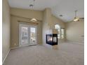 Spacious living room features a corner fireplace and sliding door to the outside at 5553 High Wager Way # 101, Las Vegas, NV 89122
