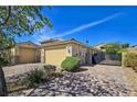 Charming single-story home features a two-car garage, desert landscaping, and gated entry at 6975 Hopi Summit Ct, Las Vegas, NV 89149