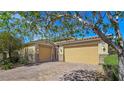 Charming single-story home with a two-car garage, desert landscaping, and gated entry at 6975 Hopi Summit Ct, Las Vegas, NV 89149