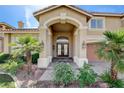 Inviting front entry with double doors, stone pathway, and desert landscaping at 7619 Belgian Lion St, Las Vegas, NV 89139