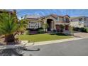 Beautiful home with manicured front yard, palm trees, and solar panels on the red tile roof at 7619 Belgian Lion St, Las Vegas, NV 89139