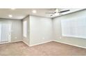 Bright bedroom with neutral walls, carpet flooring, two large windows and ceiling fan at 8101 W Flamingo Rd # 1088, Las Vegas, NV 89147
