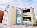 Condo building showcasing a stucco exterior, private balconies, and well-kept landscaping against a bright sky at 8101 W Flamingo Rd # 1088, Las Vegas, NV 89147