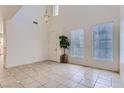 Open living area with high ceilings, tiled floors, natural light, and neutral walls at 8143 Retriever Ave, Las Vegas, NV 89147