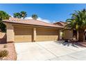 Single-story home showing a three-car garage, desert landscaping, and a concrete driveway at 9048 Faversham Ct, Las Vegas, NV 89123