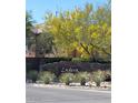 Welcoming entrance to Ladera featuring lush greenery, desert plants, and a stone sign at 10349 Mystic Pine Rd, Las Vegas, NV 89135