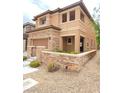 Two-story home with a two-car garage, stone accents, and low-maintenance front yard at 10349 Mystic Pine Rd, Las Vegas, NV 89135