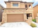 Inviting two-story home with a stone-accented facade and a convenient two-car garage at 10349 Mystic Pine Rd, Las Vegas, NV 89135