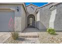 Close up of the front entrance leading to the house through a brick paved path with desert landscaping at 10456 Skye Arroyo Ave, Las Vegas, NV 89166