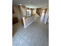 Open floor plan with a kitchen island, granite countertops, and red pendant lights at 1155 Paradise Safari Dr, Henderson, NV 89002