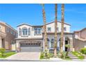 Charming two-story home featuring a symmetrical facade, arched entryway and mature palm trees at 11732 Del Sur Ave, Las Vegas, NV 89138