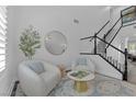 Bright living room featuring a staircase, modern decor, and neutral color palette at 11732 Del Sur Ave, Las Vegas, NV 89138
