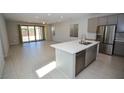 Open-concept kitchen with stainless steel appliances and a large center island at 12101 Arrebol Ave, Las Vegas, NV 89138