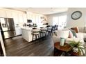 Bright, open kitchen with white cabinets, a center island with seating, and stainless steel appliances at 1288 Ventura Cliffs Ave, Henderson, NV 89012