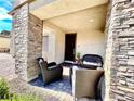 Cozy front porch featuring stone columns and outdoor seating, perfect for relaxing or welcoming guests at 1288 Ventura Cliffs Ave, Henderson, NV 89012