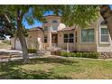 A charming single-Gathering home with lush green lawn, mature trees, and inviting front porch at 1470 St Joseph St, Overton, NV 89040