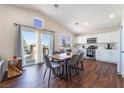 Spacious open-concept kitchen featuring stainless steel appliances, modern white cabinets, and natural light at 1808 Quartz Landing Ave, Las Vegas, NV 89183