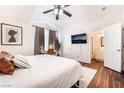 Comfortable main bedroom with wood floors, a ceiling fan, an ensuite bathroom, and natural light at 1808 Quartz Landing Ave, Las Vegas, NV 89183