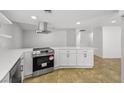 Modern kitchen showcasing stainless steel appliances, white cabinets, and tile floors at 2080 Karen Ave # 60, Las Vegas, NV 89169