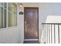 Close-up of the front door, unit 2013, with a dark brown door and a small window at 2615 W Gary Ave # 2013, Las Vegas, NV 89123