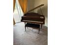 A traditional piano in a room with lots of natural light and neutral carpet at 2724 Natalie Ave, Las Vegas, NV 89121