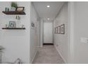 Welcoming hallway with decorative shelves and neutral color palette at 2827 Turnstone Ridge St, Henderson, NV 89044