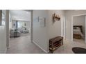 Hallway with shoe bench, coat hooks and a view into the cozy living room at 2827 Turnstone Ridge St, Henderson, NV 89044