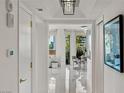 Hallway featuring white tile floors, modern lighting, and elegant artwork, leading to a comfortable living space at 2857 Paradise Rd # 305, Las Vegas, NV 89109