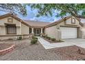 Well-maintained single-story home featuring desert landscaping, stone accents, and a two-car garage at 3104 Archwood Way, Las Vegas, NV 89134