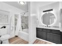 Modern bathroom with a stylish vanity, a circular mirror, and a shower-tub combination at 3151 Soaring Gulls Dr # 2136, Las Vegas, NV 89128