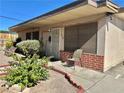 Charming single-story home featuring a secure screen door, patio seating, and desert-friendly landscaping at 4420 Avondale Ave, Las Vegas, NV 89121
