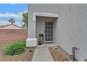 Charming front entrance with stone accents, well-maintained landscaping, and a secure screen door at 4820 Integrity St, North Las Vegas, NV 89031