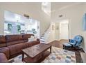 Bright living room with high ceilings, hardwood floors, staircase, and an open concept at 4820 Integrity St, North Las Vegas, NV 89031